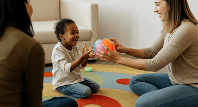 Therapist supporting a child during a learning activity